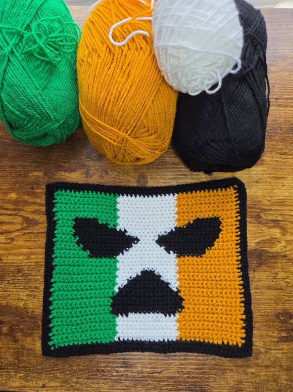 Irish flag with Kneecap logo in black on it- crochet design